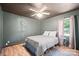 Cozy bedroom with ceiling fan, wood-look floors, and a large window letting in natural light at 112 Gays Chapel Rd, Statesville, NC 28625