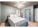 This bedroom boasts wood-look floors, a ceiling fan, and a neutral color scheme at 112 Gays Chapel Rd, Statesville, NC 28625