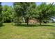 Exterior of rustic home from the backyard featuring mature trees on a sunny day at 112 Gays Chapel Rd, Statesville, NC 28625