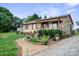 Charming single-story home with a stone walkway and lush landscaping at 112 Gays Chapel Rd, Statesville, NC 28625