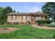 Traditional home featuring a covered porch, well-manicured lawn and mature trees at 112 Gays Chapel Rd, Statesville, NC 28625