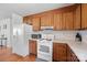 This kitchen features wood cabinets, white appliances, and a light countertop at 112 Gays Chapel Rd, Statesville, NC 28625