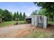 Exterior of outbuilding with gravel drive and overgrown foliage at 112 Gays Chapel Rd, Statesville, NC 28625