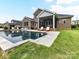 Stunning backyard featuring a sparkling pool, screened porch, and lush green lawn at 121 Enclave Meadows Ln, Matthews, NC 28104