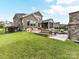Extensive backyard with pool, outdoor seating areas, and meticulously maintained lawn at 121 Enclave Meadows Ln, Matthews, NC 28104