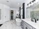 Spa-like bathroom with a modern soaking tub, glass shower, and convenient access to the living room at 121 Enclave Meadows Ln, Matthews, NC 28104