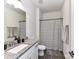 Modern bathroom with a granite vanity, large mirror, and a shower with a striped curtain at 121 Enclave Meadows Ln, Matthews, NC 28104