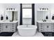 Well-lit bathroom featuring dual vanities, a soaking tub, and sleek fixtures at 121 Enclave Meadows Ln, Matthews, NC 28104