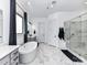 Bright primary bath with a soaking tub, glass-enclosed shower, and dual sink vanity at 121 Enclave Meadows Ln, Matthews, NC 28104