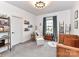 Inviting Bedroom with neutral tones, a crib, a comfy chair, and decorative shelving at 121 Enclave Meadows Ln, Matthews, NC 28104