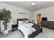 Well-lit bedroom with a king-sized bed, decorative lighting, and a modern dresser at 121 Enclave Meadows Ln, Matthews, NC 28104
