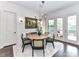 Cozy dining area with a round table, stylish chairs, chandelier, and an adjacent sitting area at 121 Enclave Meadows Ln, Matthews, NC 28104