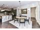 Open concept dining area with a round table, modern lighting, and view of the kitchen at 121 Enclave Meadows Ln, Matthews, NC 28104