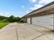 Wide driveway leading to a multi-car garage, with green lawn and landscaping at 121 Enclave Meadows Ln, Matthews, NC 28104