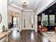 Bright foyer with dark hardwood floors leading to living spaces and white trim at 121 Enclave Meadows Ln, Matthews, NC 28104