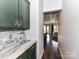 Hallway view from kitchen with marble counters, leading to living room and dining area at 121 Enclave Meadows Ln, Matthews, NC 28104