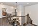 Bright hallway with stylish chandelier and wooden railings at 121 Enclave Meadows Ln, Matthews, NC 28104