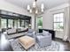 Bright living room showcasing ample seating, a cozy rug, and an open doorway to the bedroom at 121 Enclave Meadows Ln, Matthews, NC 28104