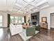 Spacious living room with stone fireplace, coffered ceiling, and ample natural light at 121 Enclave Meadows Ln, Matthews, NC 28104