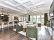 Open-concept living space with stone fireplace, coffered ceilings, and dark hardwood floors at 121 Enclave Meadows Ln, Matthews, NC 28104