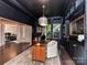 Elegant home office features a bookshelf ladder and contemporary furnishings with plenty of light at 121 Enclave Meadows Ln, Matthews, NC 28104