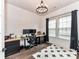 Home office features dark wood accents and light-filled windows with a modern aesthetic at 121 Enclave Meadows Ln, Matthews, NC 28104