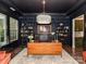 Stylish home office with custom dark shelving, ladder, and elegant light fixture at 121 Enclave Meadows Ln, Matthews, NC 28104