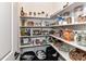 Well-stocked pantry featuring adjustable shelving and ample storage for kitchen essentials at 121 Enclave Meadows Ln, Matthews, NC 28104