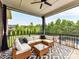 Inviting screened patio with comfortable seating, a ceiling fan, and a view of the backyard at 121 Enclave Meadows Ln, Matthews, NC 28104