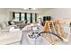 Bright playroom with a large sectional sofa, play gym, ball pit, and lots of space for activities at 121 Enclave Meadows Ln, Matthews, NC 28104
