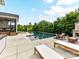 Beautiful backyard with a luxurious pool, fireplace with seating, and lounge chairs at 121 Enclave Meadows Ln, Matthews, NC 28104