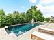Serene backyard featuring a large pool with integrated hot tub, surrounded by mature trees at 121 Enclave Meadows Ln, Matthews, NC 28104