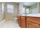 Bathroom with a vanity, toilet, mirror, and shower with gold trim, and a window at 12222 Stratfield Place Cir, Pineville, NC 28134