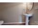 Pedestal sink bathroom with updated fixtures and a classic, minimalist design, providing a functional and stylish space at 12222 Stratfield Place Cir, Pineville, NC 28134