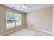 Comfortable bedroom with carpet, large window for natural light, and a ceiling fan at 12222 Stratfield Place Cir, Pineville, NC 28134