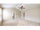 Neutral bedroom with a ceiling fan and two doorways with white trim allowing ample light at 12222 Stratfield Place Cir, Pineville, NC 28134