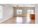 Dining area featuring hardwood floors, a chandelier, and sliding glass doors leading to the outdoor space at 12222 Stratfield Place Cir, Pineville, NC 28134