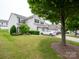 Inviting townhome featuring an attached garage, well-maintained lawn, and mature landscaping in a desirable neighborhood at 12222 Stratfield Place Cir, Pineville, NC 28134