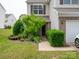 Charming front entrance with lush greenery, brick accents, and an inviting walkway leading to the front door at 12222 Stratfield Place Cir, Pineville, NC 28134