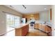 Modern kitchen showcasing hardwood floors, stainless steel appliances, and a functional island for meal preparation at 12222 Stratfield Place Cir, Pineville, NC 28134