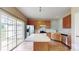 Well-lit kitchen features stainless steel appliances, a spacious island, and sliding glass doors to the backyard at 12222 Stratfield Place Cir, Pineville, NC 28134