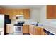 Traditional kitchen featuring oak cabinets, stainless steel appliances, and laminate countertops at 12222 Stratfield Place Cir, Pineville, NC 28134