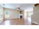 Spacious living room with a fireplace, hardwood floors, and ample natural light streaming through large windows at 12222 Stratfield Place Cir, Pineville, NC 28134