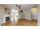 Open-concept living room with hardwood floors, a fireplace, and a staircase leading to the upper level at 12222 Stratfield Place Cir, Pineville, NC 28134