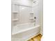 Bathroom featuring a shower and tub combo with built in shelves and white walls at 123 Prestwick Way # 42, Mooresville, NC 28115