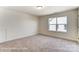 Bright bedroom features plush carpeting, a large window, and neutral paint at 123 Prestwick Way # 42, Mooresville, NC 28115