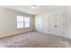 Bright bedroom features plush carpeting, two closets and a large window at 123 Prestwick Way # 42, Mooresville, NC 28115