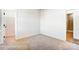 A simple bedroom that has neutral colors and carpeting and doorway access to another room at 123 Prestwick Way # 42, Mooresville, NC 28115