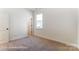 Bedroom featuring neutral carpet, ample natural light, and a view to the outside at 123 Prestwick Way # 42, Mooresville, NC 28115