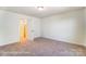 Bright bedroom features plush carpeting and neutral paint with an open door at 123 Prestwick Way # 42, Mooresville, NC 28115